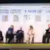 A panel discussion takes place on stage with four participants and a facilitator
