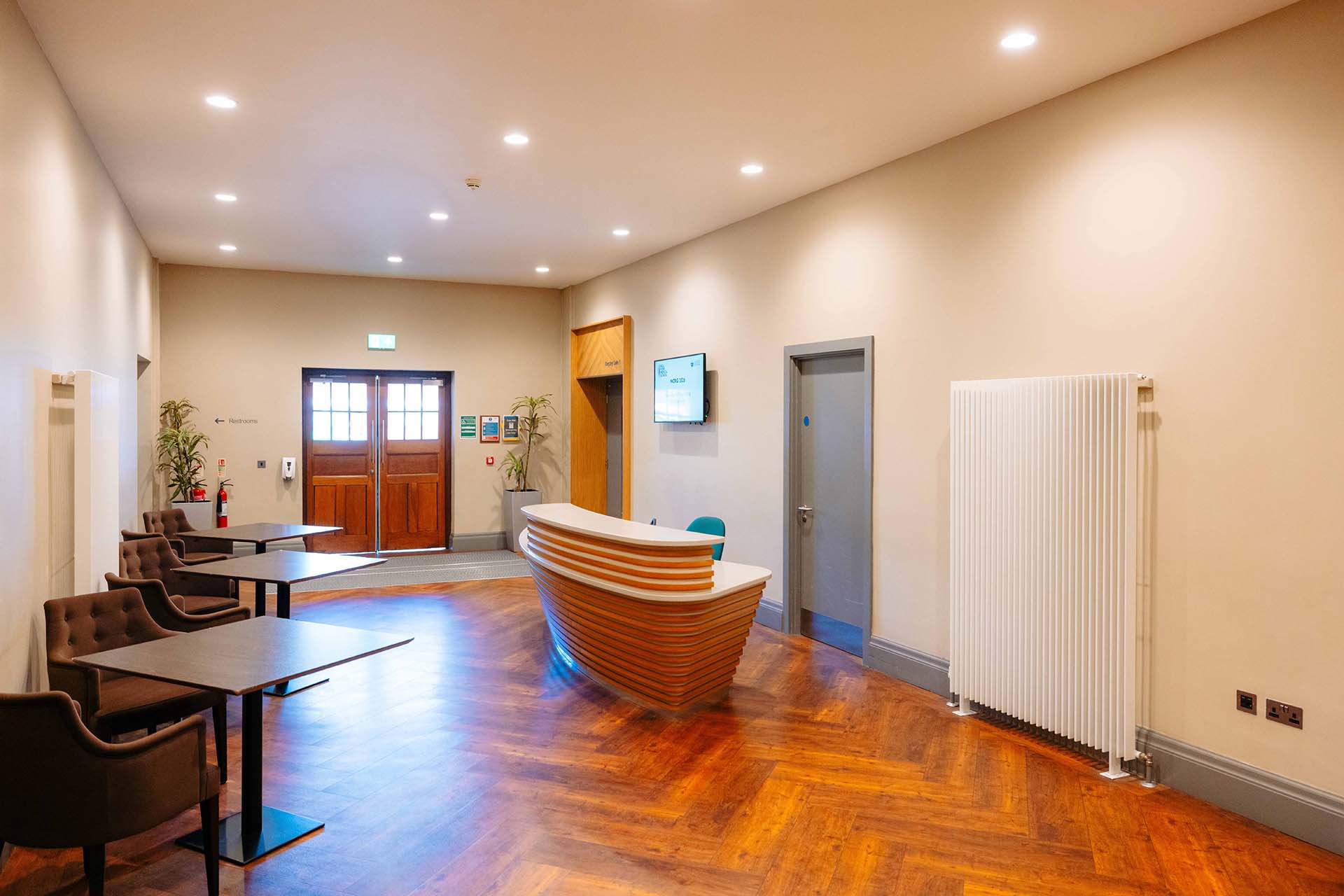 A modern reception desk outside of a large conference room