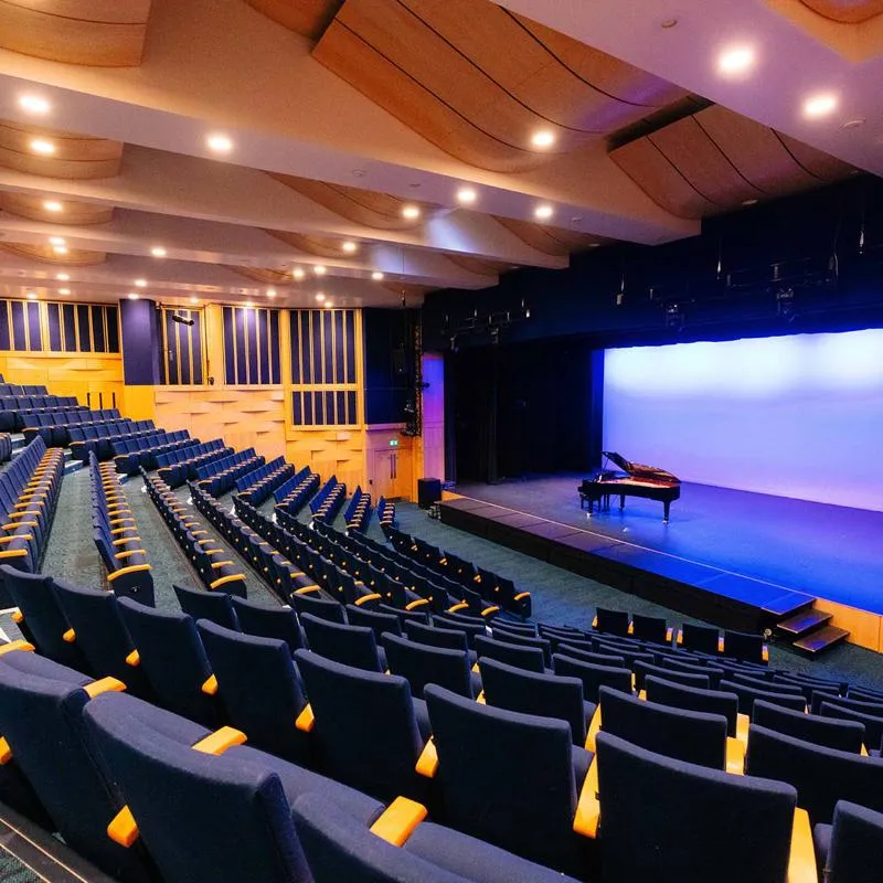 A piano on a stage in Middleton Hall