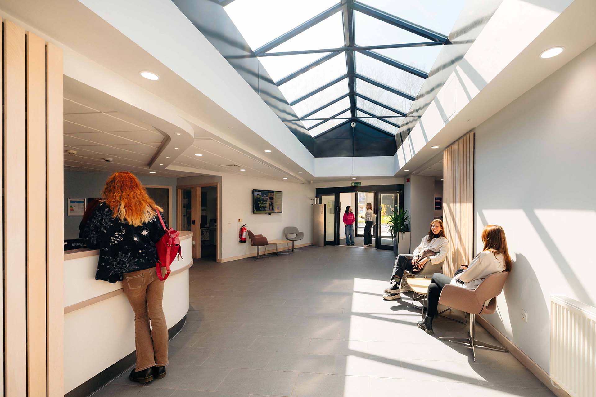 Students relaxing in the large, spacious reception area at The Courtyard.