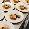 Rows of a cheesecake dessert with ice cream and berries