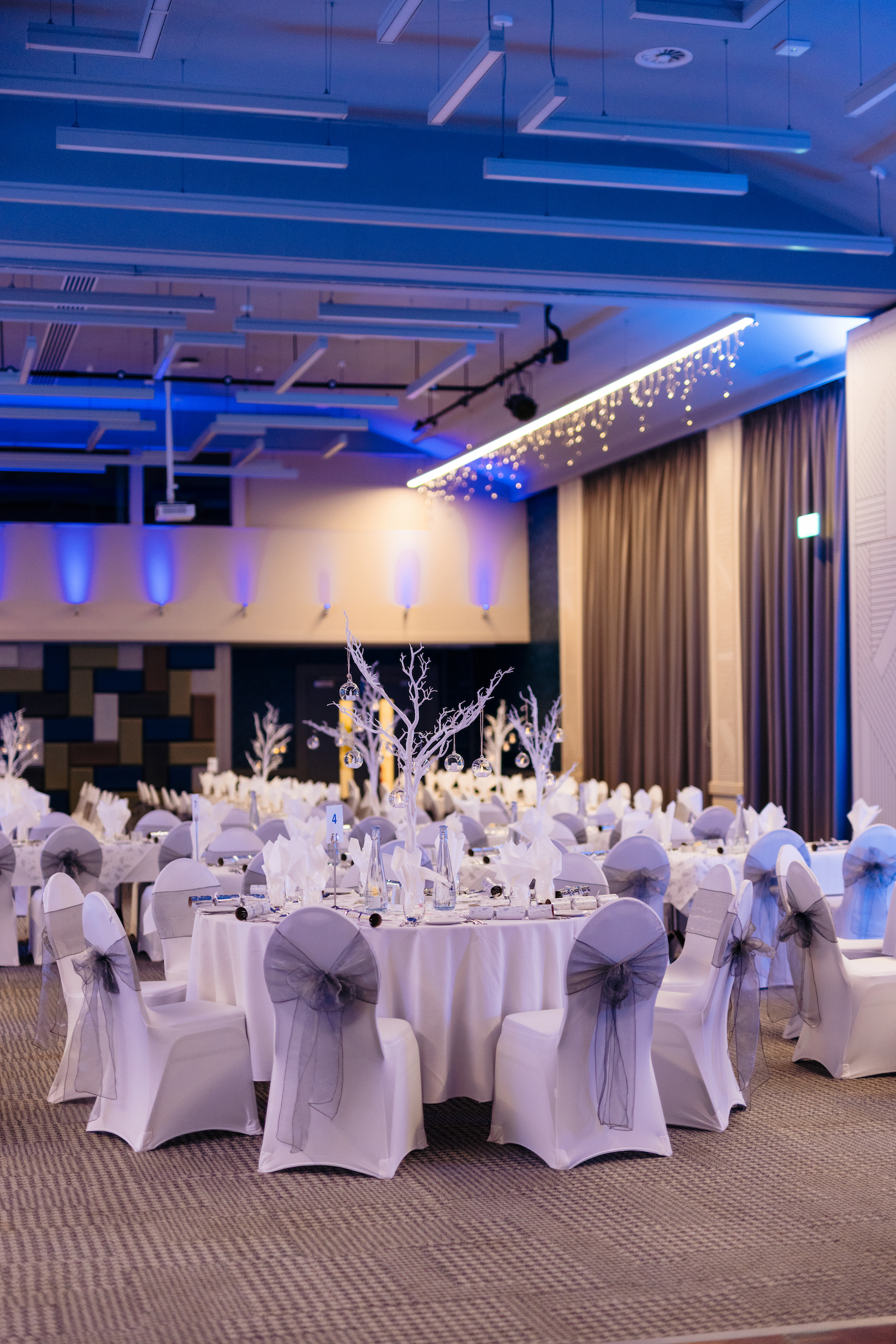 A view of tables set up for a Christmas party in the Kingsley Suite