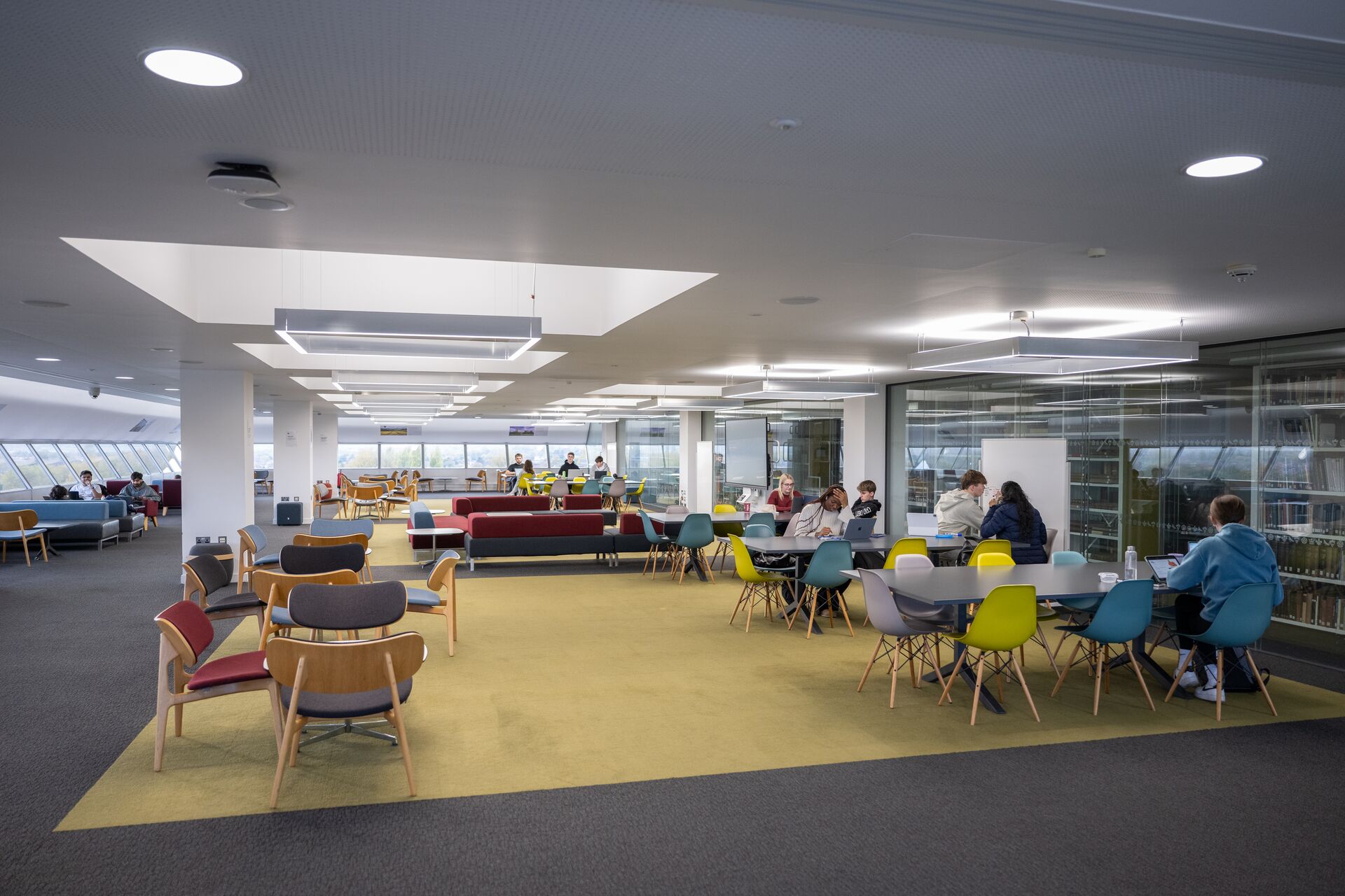 A large open plan space with furniture in various configurations for individual work, group activities and presentations