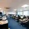 A large, modern computer suite with students sitting at banks of PCs